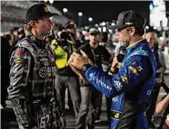  ?? Chris O'Meara/Associated Press ?? Jimmie Johnson, right, and Travis Pastrana talk before qualifying for the NASCAR Daytona 500 auto race Wednesday at Daytona Internatio­nal Speedway in Daytona Beach, Fla.