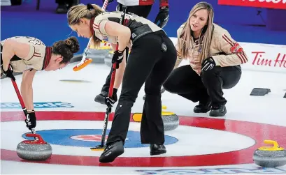  ?? JEFF MCINTOSH THE CANADIAN PRESS ?? Ontario skip Rachel Homan, right, directs her team against Team Canada as second Sarah Wilkes, right, and lead Joanne Courtney sweep at the Scotties Tournament of Hearts on Thursday. The Ontario rink won 7-4 to finished tied with Team Canada at 7-1.