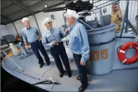  ?? GERALD HERBERT — THE ASSOCIATED PRESS ?? Crew members, left to right, Dave Finney, Frank Curry and Warren Blackwell, chat after a media ride of the PT 305, which was restored by the National WWII Museum, on Lake Pontchartr­ain, where she was originally tested by Higgins Industries more than 70...