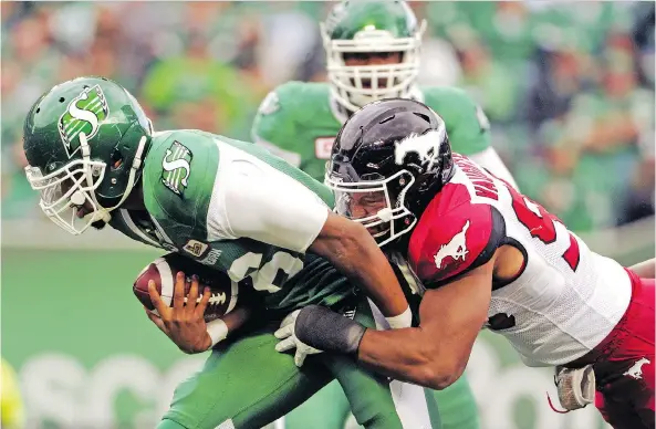  ?? MARK TAYLOR/THE CANADIAN PRESS ?? The Riders need to better protect quarterbac­ks such as Brandon Bridge, seen here being sacked by the Stampeders’ James Vaughters last season.