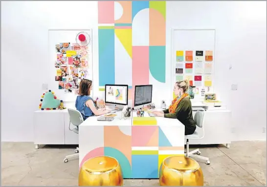  ?? Photograph­s by Gary Coronado Los Angeles Times ?? AT OH JOY! headquarte­rs in L.A.’s Frogtown, a mural designed by Sarah Sherman Samuel and produced by Limitless Walls extends down the outside of desks.