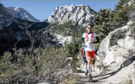  ?? DAMIEN ROSSO — DROZPHOTO — SALOMON VIA AP ?? Profession­al trail runner Francois D’haene running on the John Muir Trail in the California Sierra Nevada mountain range. D’haene, a French winemaker took fewer than three days to cover 221 miles (356 kilometers) up Mount Whitney and across the John...