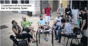  ??  ?? Customers sit on a terrace bar in Tarragona, Spain