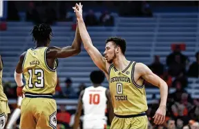  ?? ADRIAN KRAUS/ASSOCIATED PRESS ?? Georgia Tech guard Miles Kelly, celebratin­g with Lance Terry this season, has hit at least five 3-pointers in the past four games, the first Tech player to have such a streak since Lewis Clinch in the 2008-09 season.