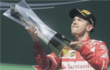  ??  ?? Ferrari driver Sebastian Vettel revels in his Brazilian Grand Prix success.