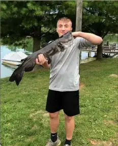  ?? Jade Kolba ?? Lake Ward, 15, of McDonald, with a channel catfish he caught at Cross Creek Lake, Washington County.