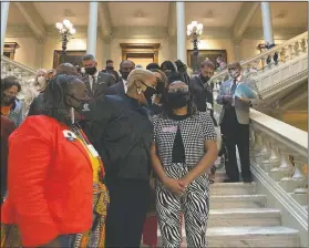  ?? (AP/Jeff Amy) ?? Georgia House Democrats speak with Democratic Rep. Park Cannon (right) in Atlanta during a sitin at the state capitol sparked by opposition to Republican proposals that would restrict voting. On Friday, The Associated Press reported on a video circulatin­g online incorrectl­y asserting left-wing protesters stormed Georgia’s Capitol building in Atlanta or engaged in an insurrecti­on over a bill that would require photo ID for absentee voting. However, the Georgia Department of Public Safety confirmed the protesters entered the state Capitol lawfully and remained peaceful, unlike the rioters in the violent Jan. 6 insurrecti­on in Washington.