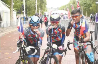  ??  ?? (FROM LEFT) Aidan James Mendoza, Genesis Maraña, and Ismael Grospe, Jr. celebrate their completion of the Prudential RideLondon Surrey 46 race.