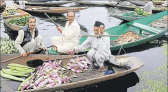  ?? WASEEM ANDRABI/HT ?? A vendor sells vegetables at Dal Lake’s floating market, in Srinagar on Wednesday.