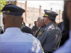  ?? RICK KAUFFMAN — DIGITAL FIRST MEDIA ?? Lt. James Hennigan, commander of the Media barracks of the Pennsylvan­ia State Police, stands among county officials and Chester police officers at the press conference last week to annouce state troopers beginning patrols in the city.