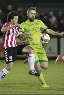  ??  ?? Ryan McEvoy keeps tabs on Derry City’s Barry McNamee.