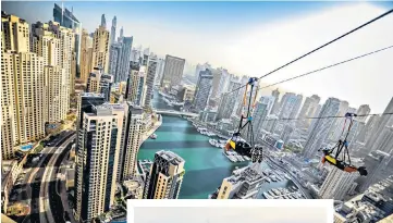  ??  ?? THE HEIGHT OF FUNThe XLine zip wire through Dubai Marina, above; paddleboar­ding in the calm waters near the Burj Al Arab, left