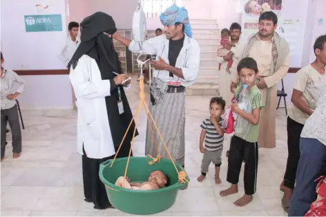  ?? — AFP ?? A Yemeni child suffering from malnutriti­on is weighed at a hospital in the northern district of Abs in the northweste­rn Hajjah province.