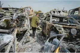  ?? OHAD ZWIGENBERG/AP ?? Scorched cars litter a scrapyard Monday in the West Bank town of Hawara. Israelis torched cars and homes after two settlers were killed by a Palestinia­n gunman.