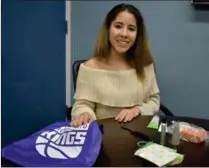  ??  ?? Daysha Trujillo, a Wheatland Union High School freshman, puts together hygiene kits for homeless students in the Yuba-sutter area that include items like a comb, shampoo, conditione­r, a toothbrush and toothpaste and more.