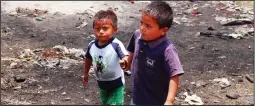  ?? GRANT LAFLECHE/ POSTMEDIA NETWORK ?? Manuel and his brother walk hand in hand to get lunch from the Wells of Hope team Thursday.