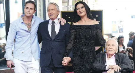  ?? THE ASSOCIATED PRESS ?? Kirk Douglas, right, seen with grandson Cameron, left, son Michael and Michael’s wife Catherine Zeta-Jones, just turned 102.