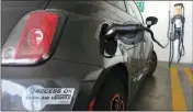  ?? ASSOCIATED PRESS ?? IN THIS 2016 FILE PHOTO, an electric Fiat is plugged into a charging station in a parking lot in Los Angeles.