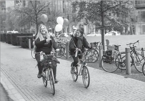  ?? SHAN YUQI / XINHUA ?? Local residents ride Mobike Technology Co’s shared bikes in Berlin, Germany. Bike-sharing titan Mobike announced on Nov 22 that it has launched services in Berlin, meeting its goal of expanding to 200 cities globally by the end of this year.