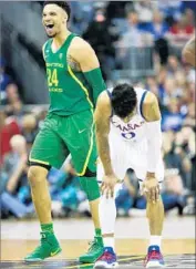  ?? Jamie Squire Getty Images ?? DILLON BROOKS of Oregon and Frank Mason III react during the Midwest Regional final on Saturday.