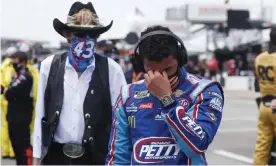  ??  ?? Bubba Wallace, right, is overcome with emotion as he and team owner Richard Petty walk to his car in the pits of the Talladega Superspeed­way on Monday. Photograph: John Bazemore/AP