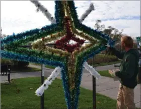  ?? BRIANA CONTRERAS — THE MORNING JOURNAL ?? Lakeview Park’s Park Manager, Bryan Goldthorpe finishes the lights on a Christmas decoration Nov. 9 in preparatio­n of Lights on the Lake. The full display will be lit Nov. 25 at dark and will keep the park bright through the end of December.