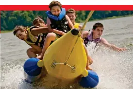  ??  ?? Fast split times: Enjoy watersport­s such as banana-boating