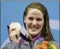  ?? MICHAEL SOHN / AP ?? Missy Franklin displays her gold medal after the 100-meter backstroke final at the 2012 Olympics, where she won four golds at age 17.