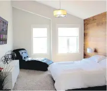  ??  ?? A horizontal­ly panelled wood feature wall adds warmth to the master bedroom in the Carlingfor­d.