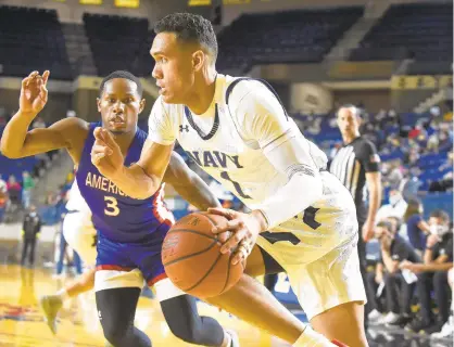  ?? PAUL W. GILLESPIE /CAPITAL GAZETTE ?? Senior swingman John Carter Jr. delivered a strong all-around game with 14 points, eight rebounds, five assists and three steals as Navy men’s basketball squeaked past American, 47-45, on Saturday at Alumni Hall.