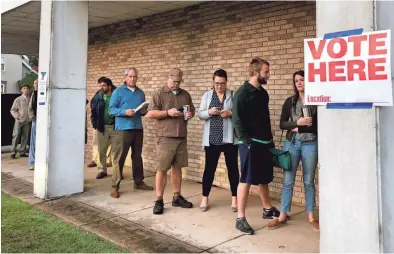  ??  ?? Voters line up at Central Christian Church on South McLean just after 6 a.m. MICAELA WATTS / THE COMMERCIAL APPEAL
