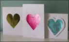  ?? HOLLY RAMER—ASSOCIATED PRESS ?? This photo taken Jan. 27, 2019 shows valentine cards made in Hopkinton, N.H. Adding foil to greeting cards can turn the simplest shape into something more fancy. These cards shown here were made by applying colored foil three different ways. The gold heart was made using doubleside­d adhesive, the pink heart was made using a laser printer and laminating machine and the blue heart was made using a a stencil and spray adhesive.