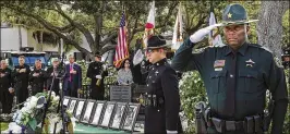  ?? LANNIS WATERS / THE PALM BEACH POST ?? Deputies Hector Sanchez (left) and Garfield Johnson salute Thursday during the posting of the colors at the Fallen Deputy Memorial ceremony.