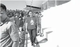  ??  ?? ON THE BLEACHERS. The football stadium in the Davao City-UP Sports Complex is also inspected by Duterte-Carpio with Asst. Prof. Erwin Protacio and former congressma­n Isidro Ungab.