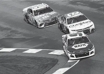  ?? Sean Gardner, Getty Images ?? Chase Elliott, front, Tyler Reddick, middle, and Kyle Busch race during the Bank of America ROVAL 400 at Charlotte Motor Speedway on Sunday in Concord, N. C.