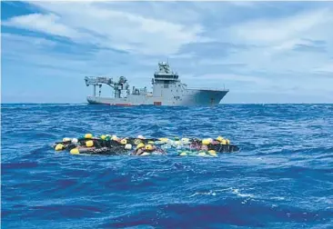  ?? NEW ZEALAND POLICE ?? Dozens of bricks of cocaine thought to be headed to Australia bob on the surface of the Pacific Ocean with a Royal New Zealand Navy vessel nearby. Police on Wednesday said they found 3.5 tons of the drug, worth $316 million, at a floating transit point after being dropped there by an internatio­nal smuggling syndicate. No arrests have been made.