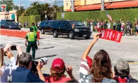  ?? Photograph: Adam Delgiudice/AFP/Getty Images ?? Supporters of Donald Trump wave as his motorcade drives past on the way to Mar-a-Lago in Florida on Wednesday.