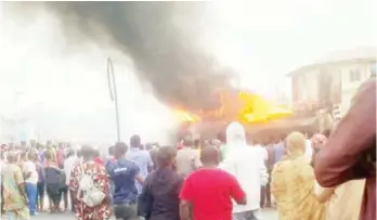  ?? PHOTO: NAN ?? People watch as petrol tanker burns at Olarem Petrol Station Bashorun, in Ibadan yesterday