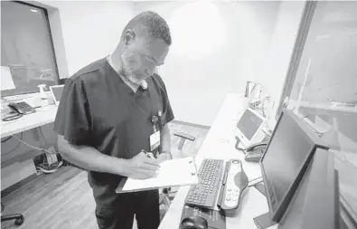  ?? JAY REEVES/AP ?? Radiology manager Marshall Pritchett Jr. works on a file May 3 at Thomasvill­e Regional Medical Center in Thomasvill­e, Ala.