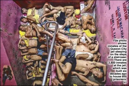  ?? AFP ?? File photo shows inmates of the Quezon City jail sleeping on the steps of a staircase. There are 3,800 inmates at the jail, which was built six decades ago to house 800 prisoners.