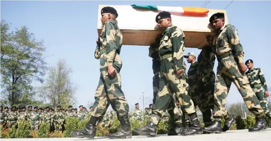  ??  ?? Indian Border Security Force (BSF) soldiers carry the coffin of their slain colleague during a wreath-laying ceremony on the outskirts of Srinagar, Indian-controlled Kashmir, Wednesday. The border guard officer was killed along with three suspected...