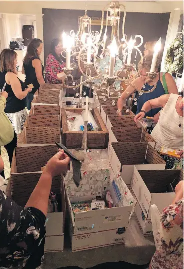  ?? — MIA WALSH ?? Mothers of university students come up with care packages for their children away at college at the home of Mia Walsh, where the Baltimore mom welcomed 15 other moms of first-year university students for a care package party.