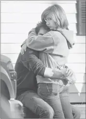  ?? Jessica Hill/the Associated Press ?? People embrace at a Newtown, Conn., firehouse staging area for family members after terrified parents across the area rushed to Sandy Hook Elementary School.