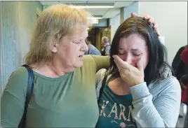  ?? CP PHOTO ?? Taylor Samson’s mother Linda Boutilier, left, and family friend Anne-Marie Anstey leave the courtroom at the murder trial of William Sandeson in Haifax yesterday.