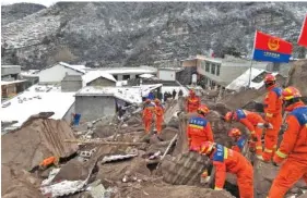  ?? XINHUA VIA AP ?? Rescue workers search the site of a landslide Monday in Liangshui village in the city of Zhaotong in southweste­rn China’s Yunnan Province.