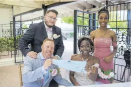  ?? ?? Signed, sealed, delivered, I’m yours... Yaneek and Christophe­r show off their marriage certificat­e. Sharing in the moment are best man Dennis Whiteway and maid of honour Tyler Rae Nesbeth Rerrie.