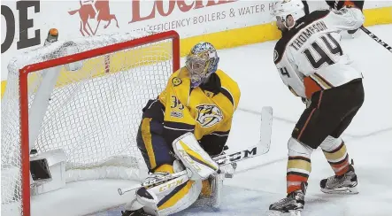  ?? AP PHOTO ?? NET GAIN: Nate Thompson watches as a shot by teammate Corey Perry (not pictured) deflects past Predators goalie Pekka Rinne to give the Ducks a 3-2 overtime victory in last night’s Game 4 in Nashville, Tenn.