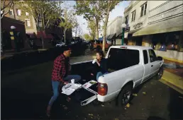  ?? RICH PEDRONCELL­I — THE ASSOCIATED PRESS ?? Calling it a COVID date, Ryan Breakfield and his girlfriend, Erica Everett, have lunch in the bed of a pickup after they were unable to eat inside a restaurant in Lodi on Wednesday.