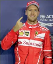 ?? — AP ?? Sebastian Vettel celebrates taking pole position in qualifying for the Singapore Grand Prixon Saturday.