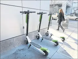  ?? LAURA A. ODA—BANG ARCHIVES ?? Three Lime-S electric scooters are parked on the corner in downtown San Jose.